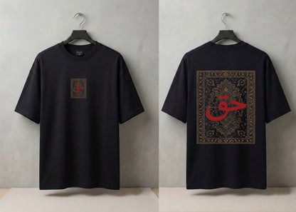 A black short-sleeve T-shirt shown from both front and back on hangers against a light gray wall. The front has a small square chest graphic with red calligraphy, and the back has a large rectangular graphic with ornate detailing and a prominent red calligraphy motif.