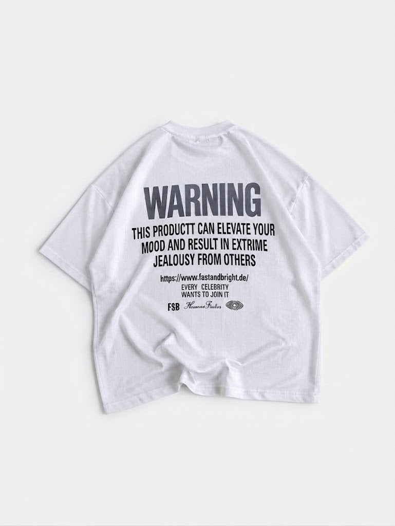 A white short-sleeve t-shirt laid flat against a light gray background, featuring a prominent black warning graphic printed on the back.
